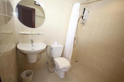 a bathroom with a toilet and a sink and a mirror at Phangan Island View - SHA Extra Plus in Ban Tai