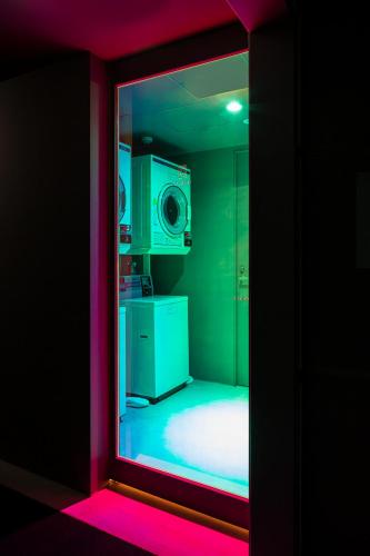 a mirror reflection of a kitchen with a microwave at TSUGU Kyoto Sanjo by THE SHARE HOTELS in Kyoto