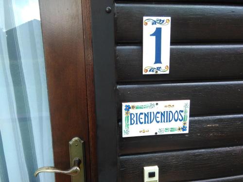 a door with a sign on it with the number one beneficiaries at Ons huisje "Bienvenidos" met garage in Durbuy