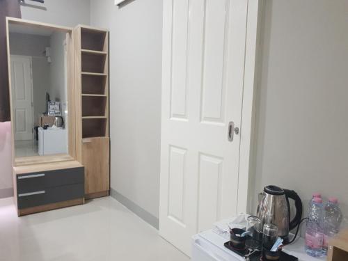 a room with a white door and a shelf at iResidence hotel in Ban Khlong Nung