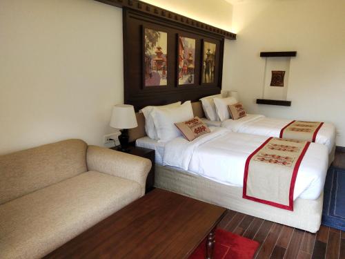 a hotel room with two beds and a couch at Chandragiri Hills Resort Kathmandu-Luxury in the Clouds in Thānkot