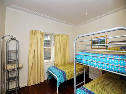 a room with two bunk beds and a window at Summer Cottage in Hawks Nest