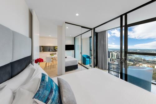 a bedroom with a bed and a view of a city at Imagine Lighthouse in Melbourne