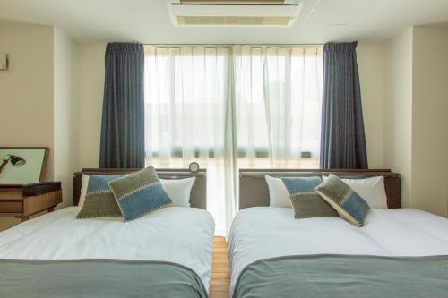Letto o letti in una camera di Minn Umeda North