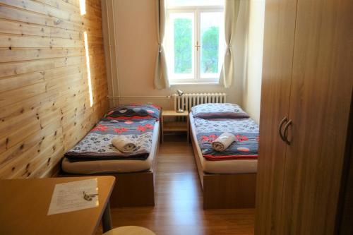 a small room with two beds and a window at Hostel Bed - Breakfast Brno in Brno