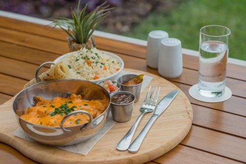 a table with a bowl of food and a bowl of rice at Garden Court Kitwe in Kitwe