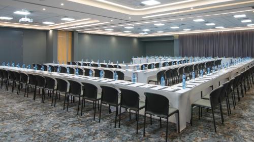 a row of tables and chairs in a room at Garden Court Kitwe in Kitwe