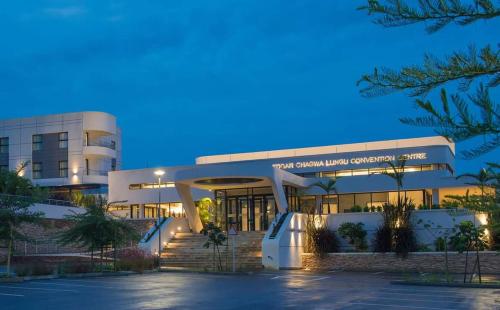 a hospital building at night with the lights on at Garden Court Kitwe in Kitwe