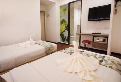 Ένα ή περισσότερα κρεβάτια σε δωμάτιο στο Yan Hotel