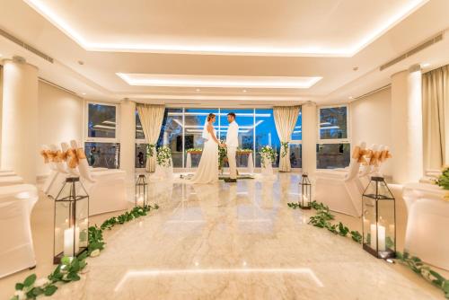 a bride and groom standing in the middle of a dance floor at tanadewa Resort Ubud Bali by Cross Collection in Ubud