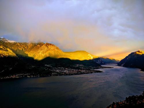 a view of the water and mountains at sunset at Villa Ponti Bellavista in Bellagio