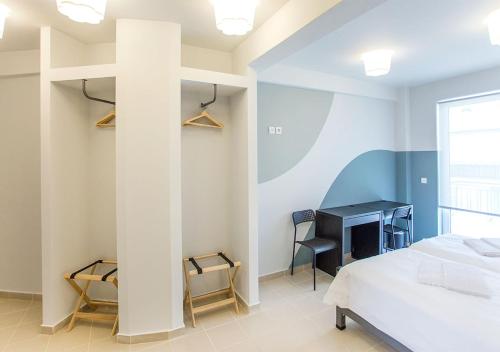 a bedroom with a bed and a desk in a room at Snooze H in Athens
