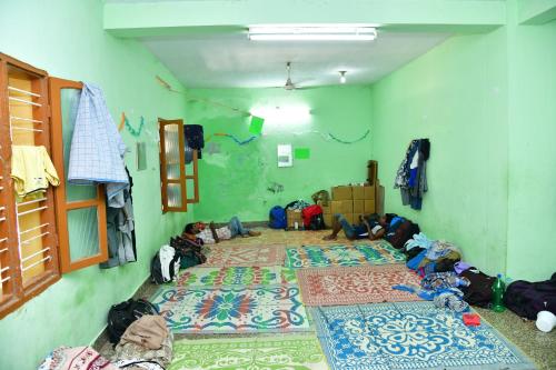a room filled with children laying on the floor at Hotel Ganesh Lodge in Kanyakumari