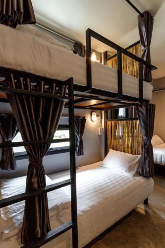 a couple of bunk beds in a room at Hostel One Art and Gallery in Chiang Mai