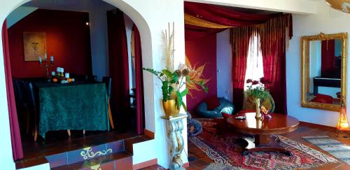 a living room with a table and a mirror at Ashram Villa Sunshine in Sitges