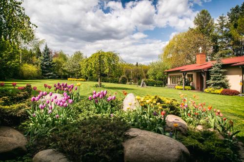 a garden with flowers and rocks in a yard at Hotel Platan in Gdańsk