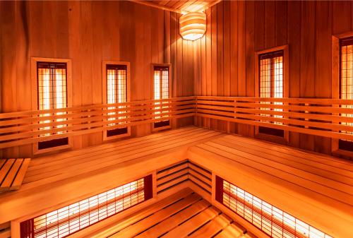 a large empty room with wood paneling and windows at Hotel Platan in Gdańsk