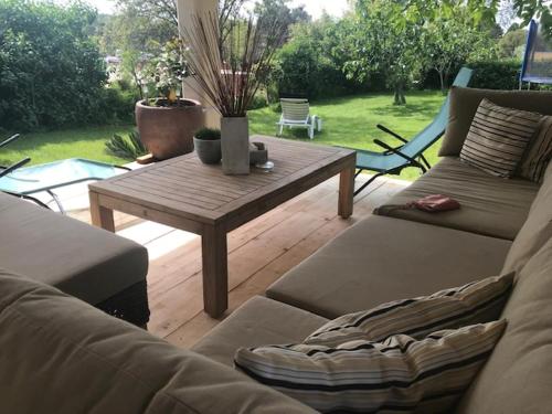 a living room with couches and a wooden table at Stone house Chiara Seaview in Funtana