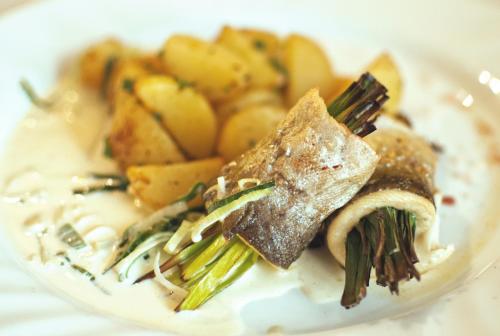 a plate of food with vegetables on a table at Restaurace a Penzion Praha in Dolní Dunajovice