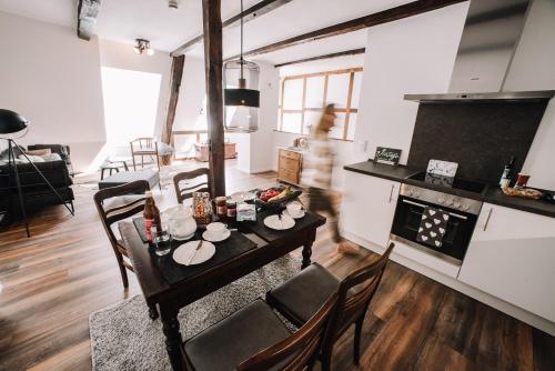 a kitchen and living room with a table with food on it at Ferienwohnung Sonnenschein in Lengerich