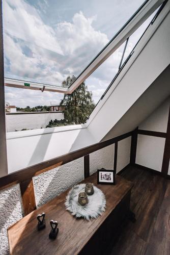 a balcony with a table and a large window at Ferienwohnung Sonnenschein in Lengerich