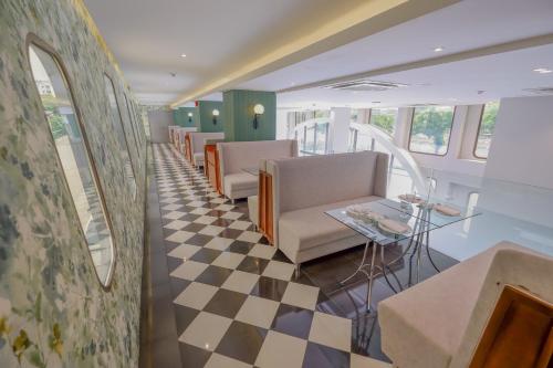 a waiting room with chairs and a checkered floor at Justice Hotel in Bangkok