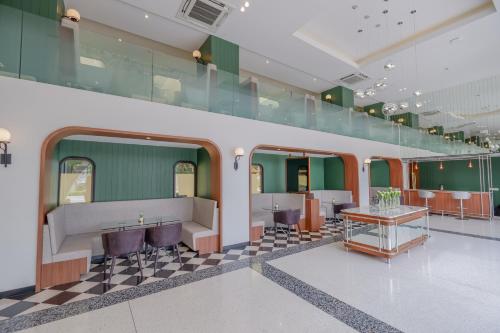 a room with a checkered floor and green walls at Justice Hotel in Bangkok
