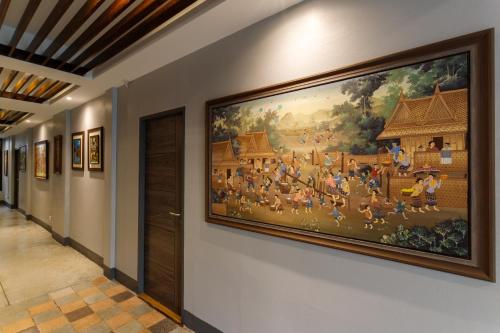 a large painting on a wall in a hallway at Hostel One Art and Gallery in Chiang Mai