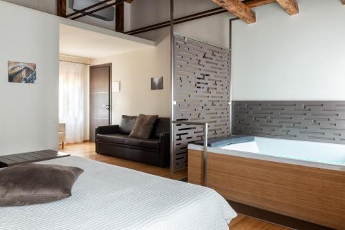 a bedroom with a bath tub and a couch at B&B Casin dei Nobili in Venice
