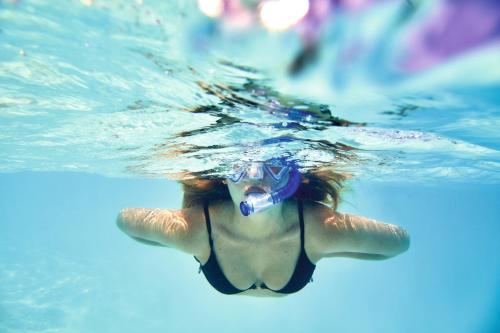 a woman in a swimming pool with her mouth open at Riu Atoll-All Inclusive in Dhaalu Atoll