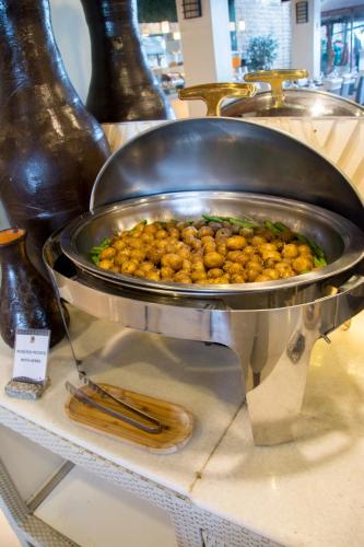 a pan filled with food on a shelf at Sur Beach Resort Boracay in Boracay