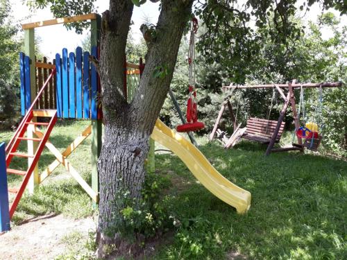 a playground in a yard with a tree at Dworska Zagroda in Korytowo