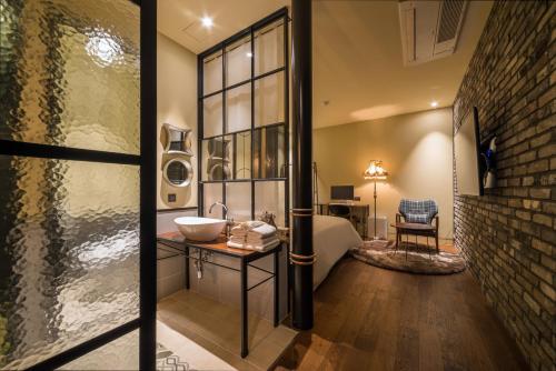 a bathroom with a sink and a brick wall at Hotel March in Daejeon
