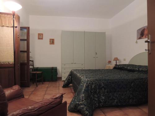 a bedroom with a bed and a cabinet in it at Agriturismo Podere Borgognano in Massa Marittima