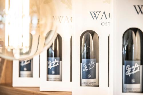 a row of wine bottles on a shelf at Donauschlössel in Spitz