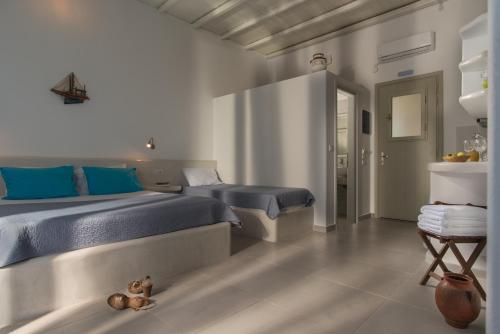 a bedroom with two beds and a teddy bear on the floor at Pollonia Center Studios in Pollonia