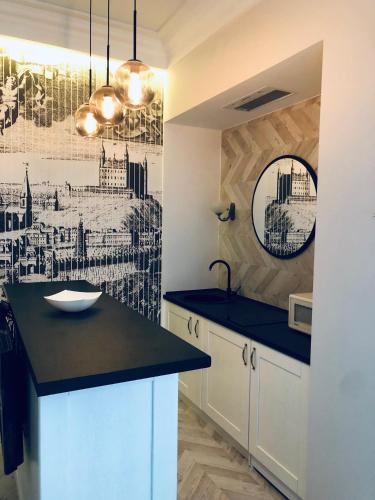 a kitchen with a black counter top and a sink at VIP apartment history in Lviv