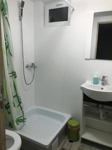 a bathroom with a tub and a sink and a toilet at Estelle in Costinesti
