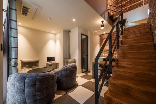 a living room with two couches and a desk at Hotel March in Daejeon