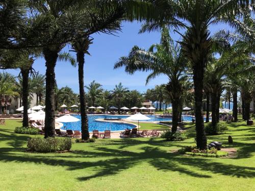 a resort with a pool and palm trees at Palm Garden Beach Resort & Spa in Hoi An