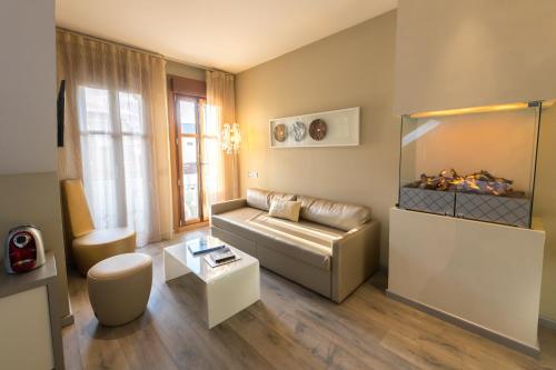 a living room with a couch and a table at Hotel & Spa Princesa Munia in Oviedo