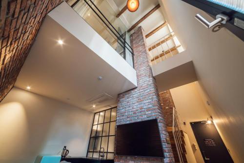 a room with a brick wall and a window at Hotel March in Daejeon