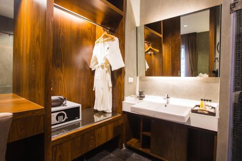uma casa de banho com um lavatório e um espelho em NAI YA Hotel -SHA Extra Plus em Chiang Rai