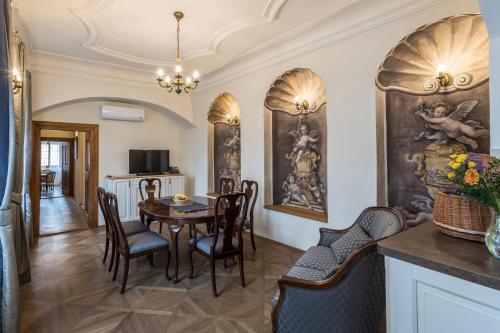 a dining room with a table and chairs at Residence U Mecenáše in Prague