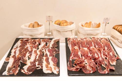 two racks of meat and bread on a table at Hotel & Spa Princesa Munia in Oviedo