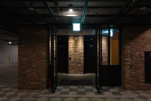 a room with glass doors and brick walls at Hotel March in Daejeon