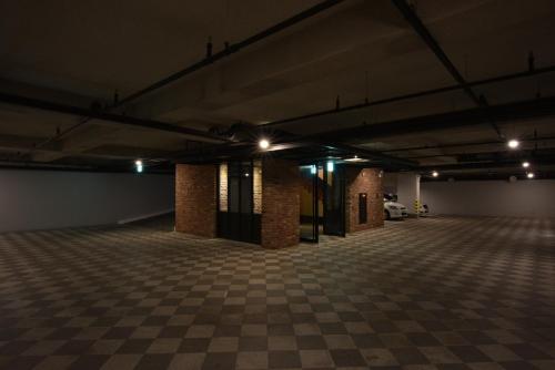 an empty parking garage with brick columns and lights at Hotel March in Daejeon