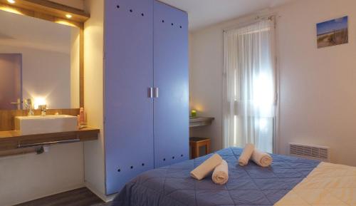 Postel nebo postele na pokoji v ubytování VVF Soulac-sur-Mer Bordeaux Médoc