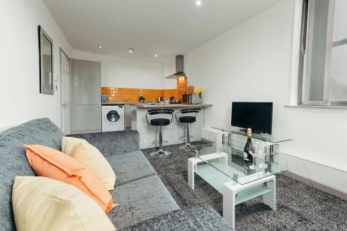 a living room with a couch and a glass table at Halifax House, One Bedroom Apartment 216 in Halifax