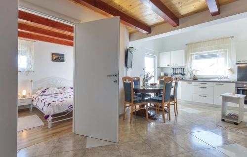 a kitchen and a bedroom with a table and a bed at Apartmani Lisicak in Vodnjan